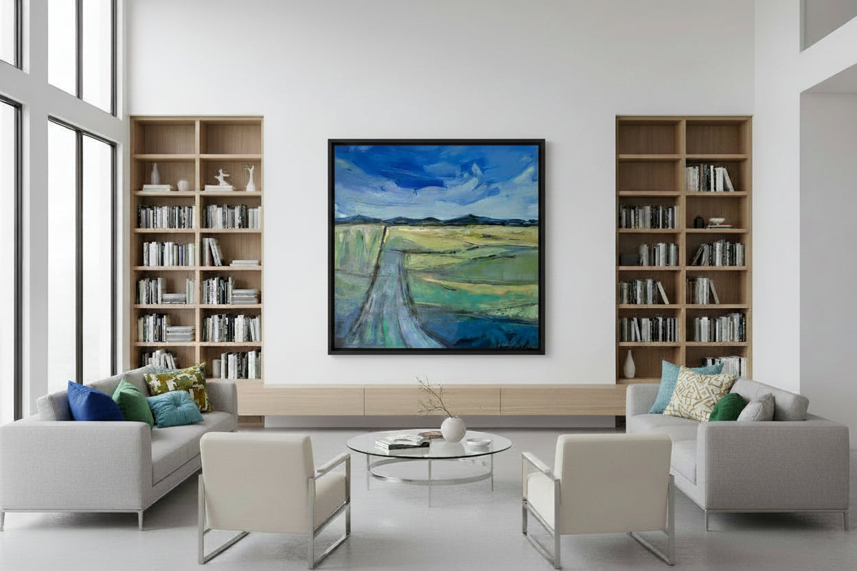 Modern living room with bookshelves, artwork, and furniture.