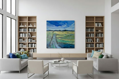 Modern living room with bookshelves, artwork, and furniture.