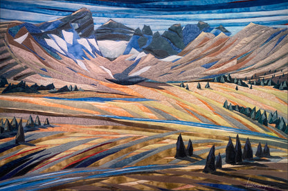 Stitched fabric tapestry reproduction of a mountain landscape with trees and a lake.